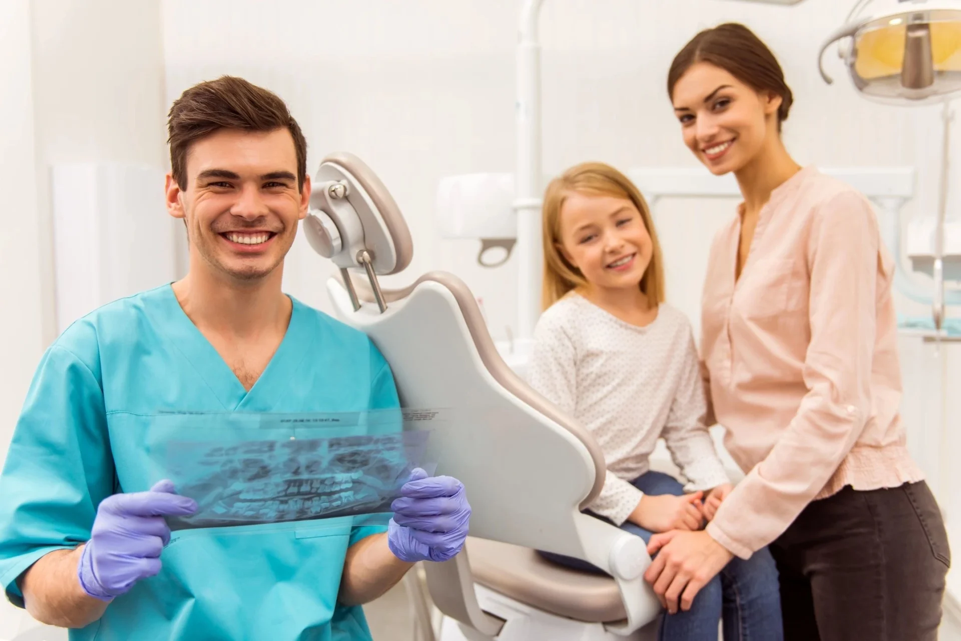A dentist with two women and one girl.