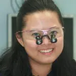 A woman wearing glasses with two pairs of eyes.